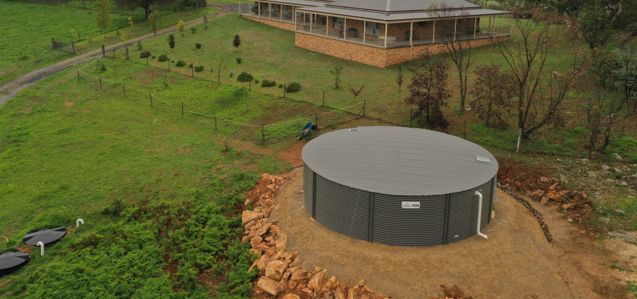 Colorbond water tank beside a home