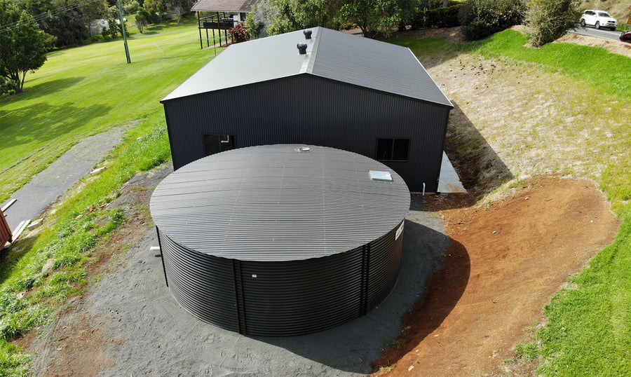 Colorbond tank beside a shed